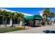 Waterford Golf Club's inviting entrance with lush landscaping and a convenient covered drop-off area at 1400 Colony Pl, Venice, FL 34292