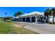 Waterford Golf Club featuring a tiled roof, ample parking, and lush landscaping, offering a premier recreational experience at 1400 Colony Pl, Venice, FL 34292
