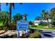 Waterford Colony Place entrance sign with lush landscaping, mature palms, and attractive flowering shrubs at 1400 Colony Pl, Venice, FL 34292