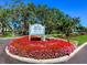 Welcoming Waterford Golf Club entrance with vibrant flower beds and clear signage for easy navigation at 1400 Colony Pl, Venice, FL 34292