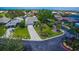 Exterior of a single-story home with a driveway, manicured lawn, and lush landscaping at 1400 Colony Pl, Venice, FL 34292