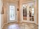 Foyer includes decorative front door, neutral walls and easy access to the living area at 1400 Colony Pl, Venice, FL 34292