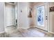 Bright entryway features neutral walls, decorative glass front door, and tile flooring at 1400 Colony Pl, Venice, FL 34292