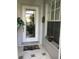Elegant front door with decorative glass and a tiled porch welcomes you home at 1400 Colony Pl, Venice, FL 34292