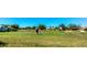 Panoramic view of golfers enjoying the well-manicured green on a beautiful golf course at 1400 Colony Pl, Venice, FL 34292