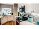 Kitchen with marble backsplash, modern appliances and access to living room at 1400 Colony Pl, Venice, FL 34292