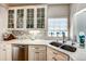 Close-up of white cabinets, marble countertop, and stainless steel appliances at 1400 Colony Pl, Venice, FL 34292
