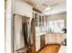 Bright kitchen featuring stainless steel appliances and wooden floors at 1400 Colony Pl, Venice, FL 34292
