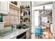 Kitchenette with white cabinets, marble countertops, and a bright turquoise dining set at 1400 Colony Pl, Venice, FL 34292