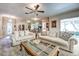 Bright living room with comfortable sofas, stylish coffee table, and elegant ceiling fan at 1400 Colony Pl, Venice, FL 34292