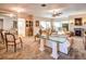 Spacious living room with neutral tones, glass table, fireplace, and access to other rooms at 1400 Colony Pl, Venice, FL 34292