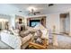 Well-lit living room with neutral walls, fireplace, comfortable seating and a glass table at 1400 Colony Pl, Venice, FL 34292