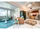 Bright living room with comfortable seating, and sliding glass door access to exterior at 1400 Colony Pl, Venice, FL 34292
