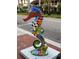 Unique, colorful seahorse statue adorned with sports themes on a city sidewalk at 1400 Colony Pl, Venice, FL 34292