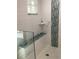 Shower with modern tile, built-in seating and storage at 1400 Colony Pl, Venice, FL 34292