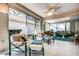 Bright sunroom featuring comfortable seating and large windows at 1400 Colony Pl, Venice, FL 34292