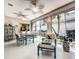 Dining area in sunroom with tile floors, and sliding glass door access to exterior at 1400 Colony Pl, Venice, FL 34292