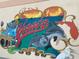 Vibrant Venice, Florida wall mural featuring dolphins, vintage airplane, and a sunset over the Gulf at 1400 Colony Pl, Venice, FL 34292