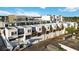 Modern townhouse complex aerial view showcasing rooftop patios and manicured landscaping at 1558 4Th St # 208, Sarasota, FL 34236