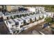 Aerial view showcasing modern townhouses with rooftop patios, and street parking at 1558 4Th St # 208, Sarasota, FL 34236