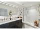 Contemporary bathroom featuring a double vanity, illuminated mirror, and a glass walk-in shower at 1558 4Th St # 208, Sarasota, FL 34236