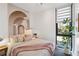 Inviting bedroom featuring a neutral palette, arched wall art, and a large window for natural light at 1558 4Th St # 208, Sarasota, FL 34236