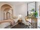 Cozy bedroom with a mural, a desk, and a neutral palette creates a serene space at 1558 4Th St # 208, Sarasota, FL 34236