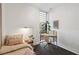 Comfortable bedroom featuring desk area, soft lighting, neutral colors, and hardwood floors at 1558 4Th St # 208, Sarasota, FL 34236