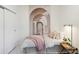 Bedroom featuring mural, soft lighting, neutral colors, and hardwood floors at 1558 4Th St # 208, Sarasota, FL 34236