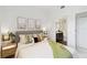 Bright bedroom with ensuite bathroom, coastal decor, and cozy textiles create a relaxing retreat at 1558 4Th St # 208, Sarasota, FL 34236