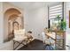 Bedroom featuring mural, desk area, soft lighting, neutral colors, and hardwood floors at 1558 4Th St # 208, Sarasota, FL 34236
