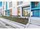 This building exterior showcases two separate entry doors with glass panels and bushes on the ground at 1558 4Th St # 208, Sarasota, FL 34236