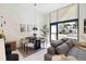 Dining area with a modern table and chairs, complemented by natural light from a large window at 1558 4Th St # 208, Sarasota, FL 34236