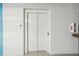 A modern elevator with closed doors in a clean, well-lit hallway, next to a fire extinguisher at 1558 4Th St # 208, Sarasota, FL 34236