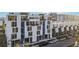 Modern townhome complex featuring clean lines, large windows, and multiple stories at 1558 4Th St # 208, Sarasota, FL 34236