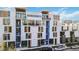 Modern townhouse exterior boasting contemporary design with balconies and ample street parking at 1558 4Th St # 208, Sarasota, FL 34236