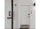 A view of a well-lit front door on a white wall with the unit number displayed on the right side at 1558 4Th St # 208, Sarasota, FL 34236
