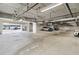 An indoor parking garage with white and grey vehicles in the distance at 1558 4Th St # 208, Sarasota, FL 34236