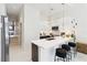 Modern kitchen with a large island, white cabinets, stainless steel appliances, and elegant lighting at 1558 4Th St # 208, Sarasota, FL 34236