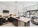 Bright, open kitchen with stainless steel appliances, counter seating, and a door to the outdoor patio at 1558 4Th St # 208, Sarasota, FL 34236