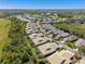 Aerial view of a residential community featuring a scenic landscape with lakes and lush greenery at 1567 Monarch Dr, Venice, FL 34293