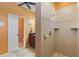 Walk-in shower and vanity in the bathroom featuring cream-colored tile and hardware at 1567 Monarch Dr, Venice, FL 34293
