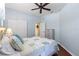 Comfortable bedroom with a queen bed, ceiling fan, wood floors and a closet at 1567 Monarch Dr, Venice, FL 34293