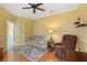 Bright bedroom featuring a ceiling fan, hardwood floors and an adjoining bathroom at 1567 Monarch Dr, Venice, FL 34293