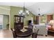 Inviting dining area with a chandelier, seamlessly connecting to the living room and outdoor views at 1567 Monarch Dr, Venice, FL 34293