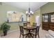 Charming dining area with a chandelier and views into the kitchen and living spaces at 1567 Monarch Dr, Venice, FL 34293
