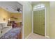 Inviting entryway with olive colored door, and a glimpse of a living room with tan sofa and a brown recliner at 1567 Monarch Dr, Venice, FL 34293