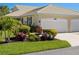 Charming one-story home featuring a well-manicured lawn and a convenient two-car garage at 1567 Monarch Dr, Venice, FL 34293