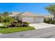 Attractive single-story home with attached two car garage, well manicured lawn and mature landscaping at 1567 Monarch Dr, Venice, FL 34293