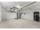 Spacious two car garage with air conditioning, water heater, door to outside, and painted white floor at 1567 Monarch Dr, Venice, FL 34293
